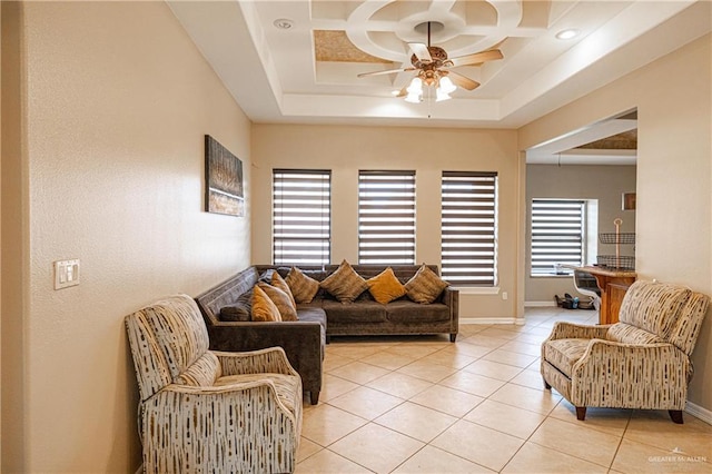 living room with light tile patterned floors and a raised ceiling