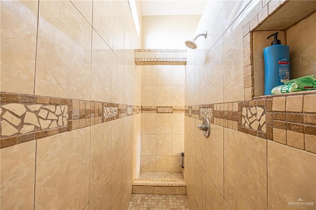 bathroom featuring a tile shower and tile walls