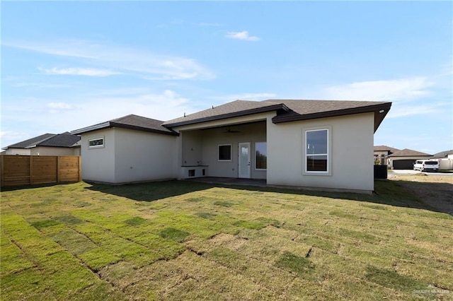 rear view of house featuring a lawn