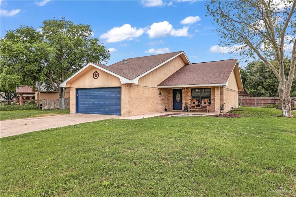 single story home featuring a garage, covered porch, and a front lawn