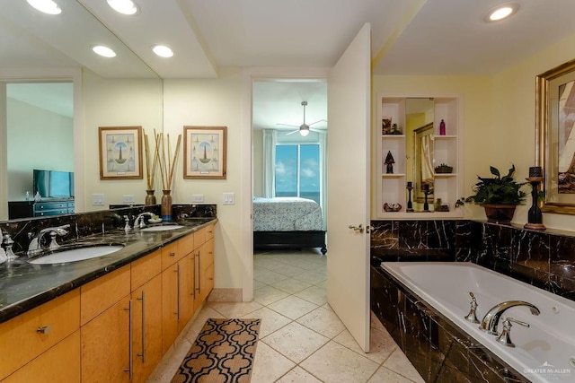 bathroom featuring tile patterned flooring, vanity, tiled bath, and ceiling fan