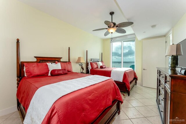 tiled bedroom featuring ceiling fan