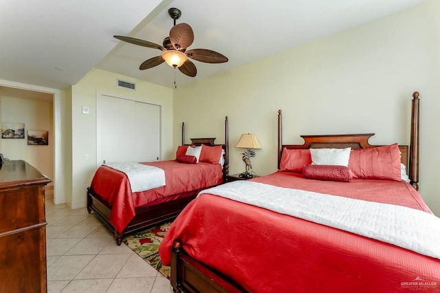 tiled bedroom with ceiling fan