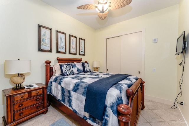 bedroom featuring ceiling fan, a closet, and light tile patterned floors