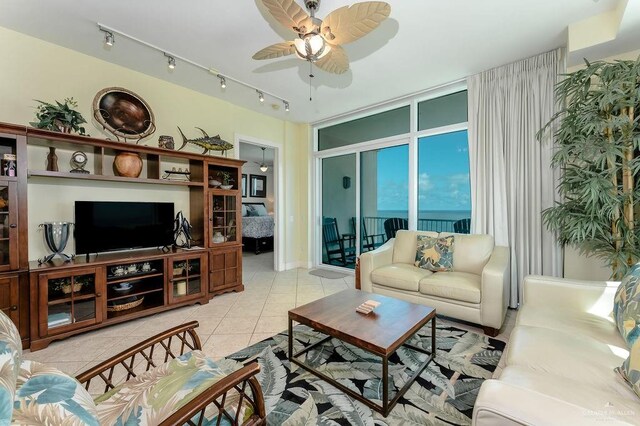 living room featuring light tile patterned floors, track lighting, and ceiling fan