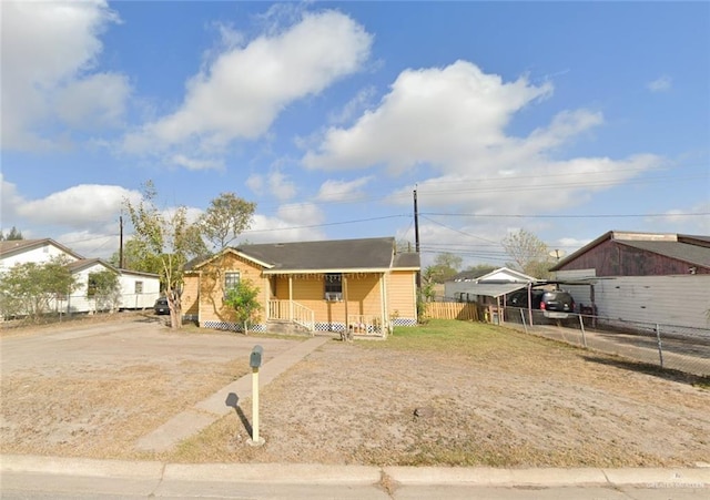 306 Cleveland Ave, Harlingen, TX 78550 - view of front of house featuring covered porch, fence, and a detached carport