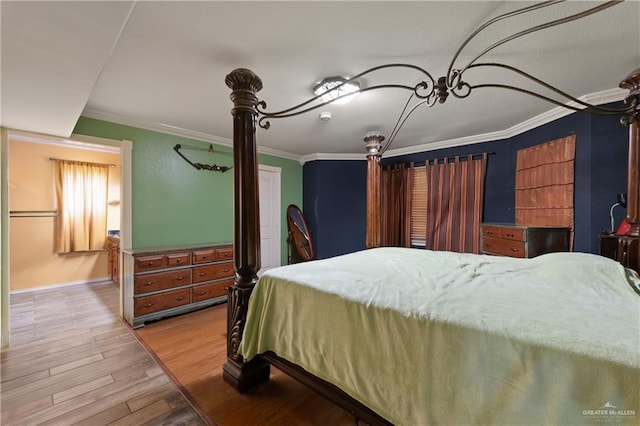 bedroom with crown molding, baseboards, and wood finished floors
