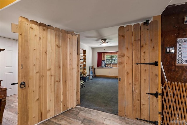 hall featuring wood finished floors and carpet flooring