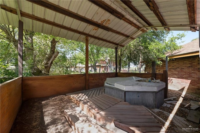 wooden terrace with a covered hot tub