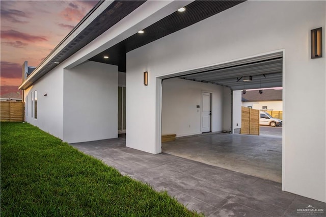 garage at dusk with a carport