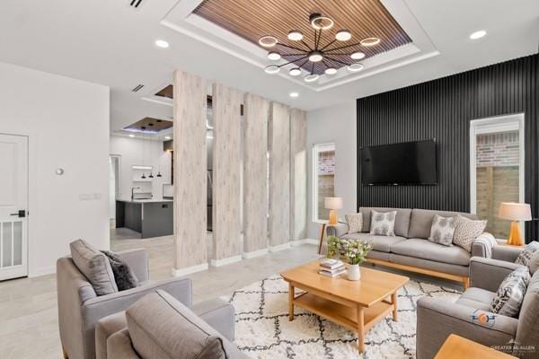 living room with wood ceiling and a raised ceiling