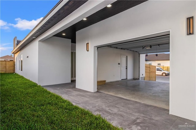 garage featuring a yard and a carport