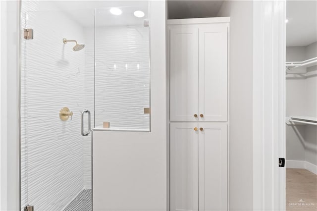 bathroom featuring a shower with shower door