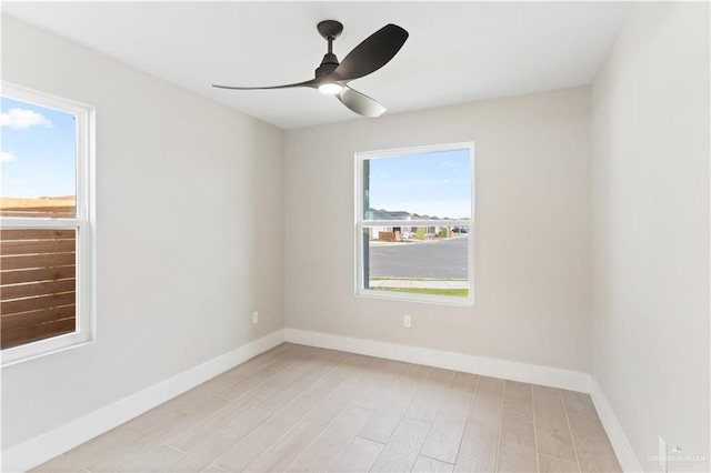 spare room featuring ceiling fan and light hardwood / wood-style floors