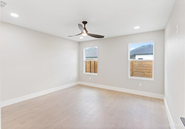 empty room featuring ceiling fan and light hardwood / wood-style flooring