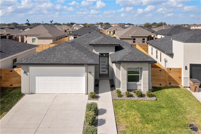 view of front facade featuring a garage and a front lawn