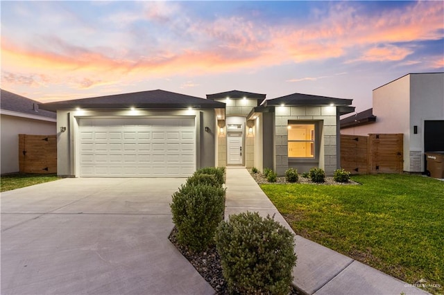 view of front facade featuring a lawn and a garage