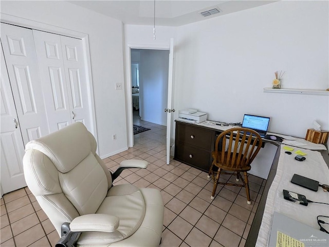 home office featuring light tile patterned flooring and visible vents