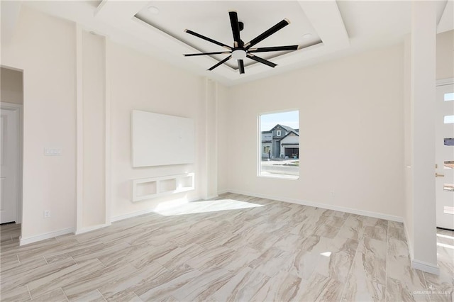 unfurnished room featuring a tray ceiling and ceiling fan