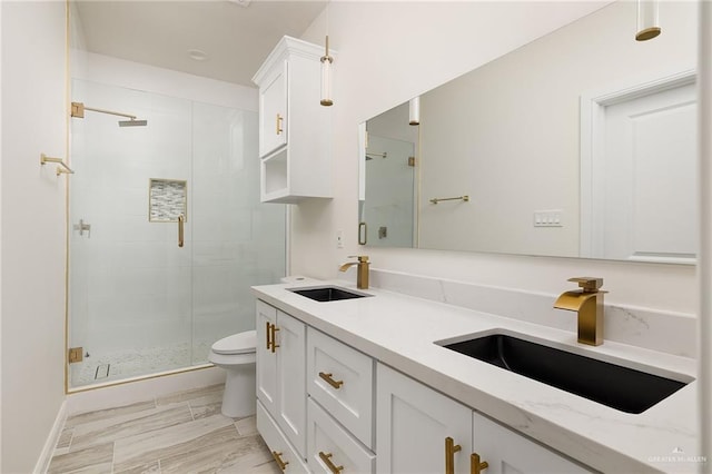 bathroom featuring vanity, toilet, and walk in shower