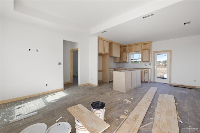 kitchen featuring light brown cabinets, a tray ceiling, a kitchen island, and hardwood / wood-style flooring