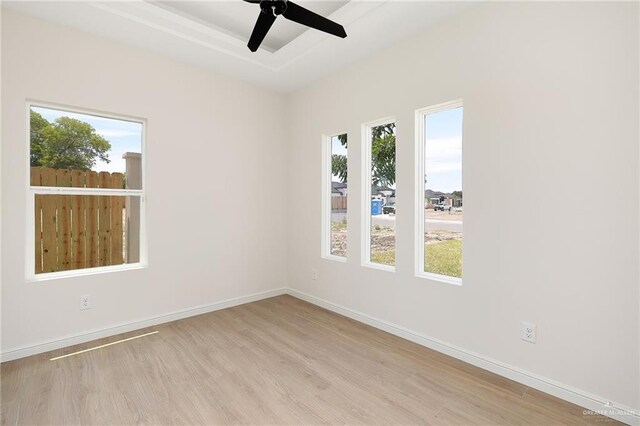 4909 Columbia Ave, Mcallen, TX 78504 - spare room featuring wood finished floors, baseboards, a ceiling fan, and a raised ceiling