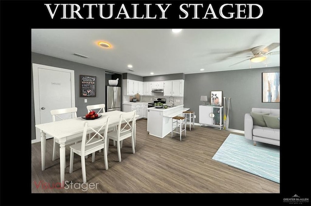 dining area featuring hardwood / wood-style flooring, ceiling fan, and sink