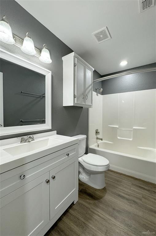 full bathroom featuring toilet, vanity, shower / bath combination, and hardwood / wood-style flooring