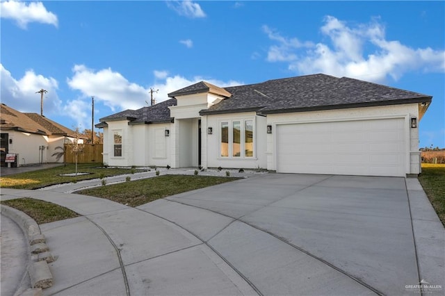 view of front of home with a garage, driveway, fence, a front lawn, and stucco siding