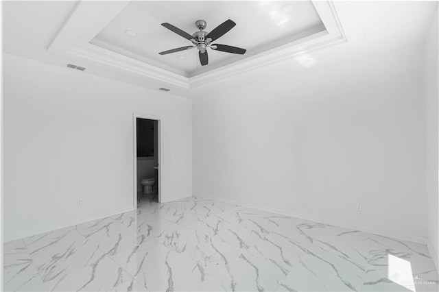 unfurnished room with a raised ceiling and ceiling fan