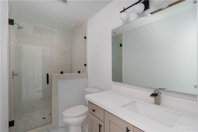 bathroom with vanity, toilet, and a shower with door