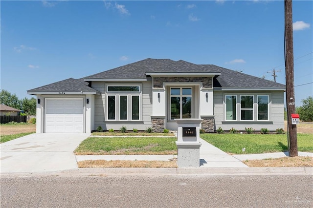 prairie-style home featuring a front yard and a garage