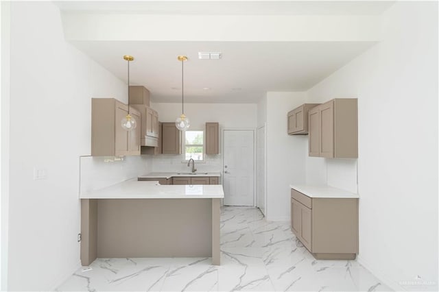 kitchen with tasteful backsplash, kitchen peninsula, sink, and decorative light fixtures