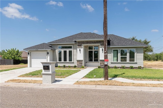 view of front of house featuring a garage and a front yard