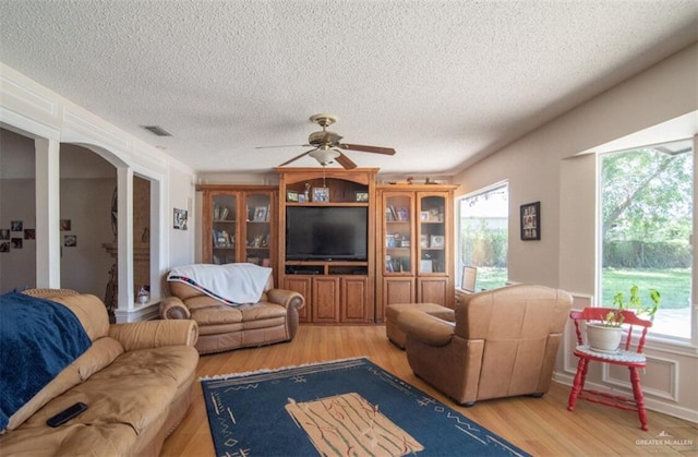2517 E Mile 4th Rd, Mission, TX 78573 - living area featuring plenty of natural light, a ceiling fan, light wood-style floors, and a textured ceiling
