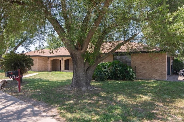 2517 E Mile 4th Rd, Mission, TX 78573 - ranch-style house with brick siding and a front lawn