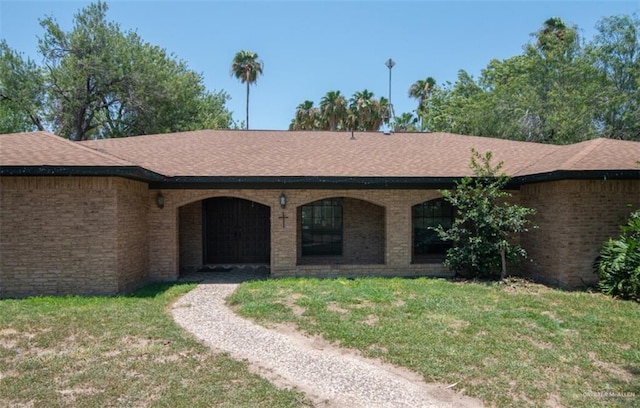 2517 E Mile 4th Rd, Mission, TX 78573 - view of front facade featuring a front yard, brick siding, and a shingled roof