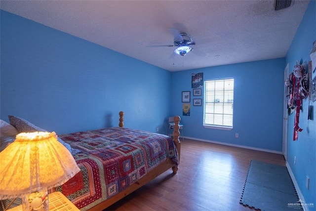 2517 E Mile 4th Rd, Mission, TX 78573 - bedroom featuring wood finished floors, a textured ceiling, baseboards, and a ceiling fan