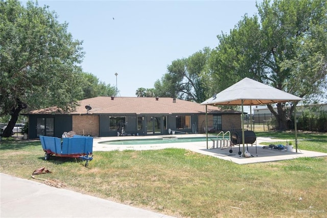 2517 E Mile 4th Rd, Mission, TX 78573 - rear view of property featuring an outdoor pool and a patio area