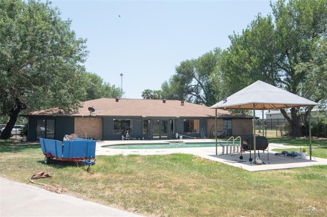 2517 E Mile 4th Rd, Mission, TX 78573 - back of house featuring an outdoor pool, a yard, and a patio