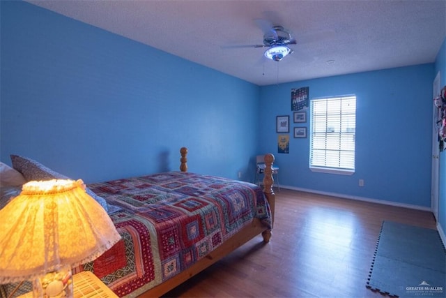 2517 E Mile 4th Rd, Mission, TX 78573 - bedroom with wood finished floors, baseboards, a ceiling fan, and a textured ceiling