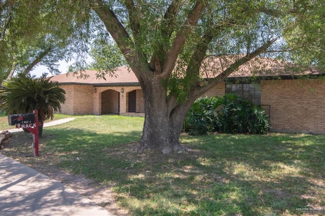 2517 E Mile 4th Rd, Mission, TX 78573 - single story home with brick siding and a front yard