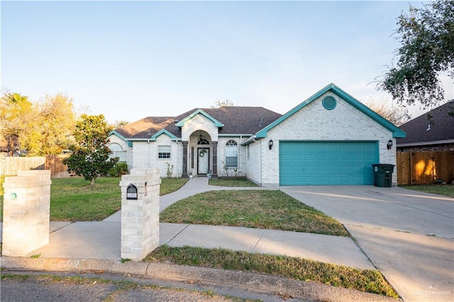 ranch-style home with a front yard and a garage