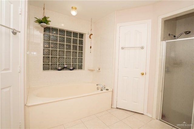 bathroom featuring tile patterned flooring and independent shower and bath