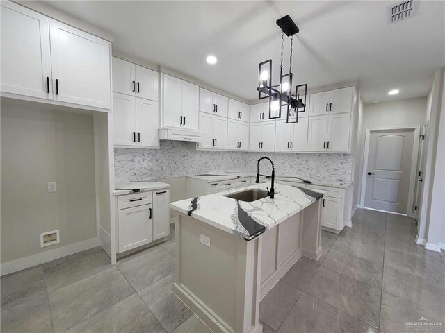 kitchen with white cabinets, decorative light fixtures, and sink