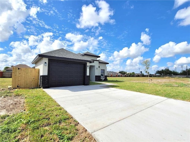 2900 E Palo Blanco St, Hidalgo, TX 78557 - view of front of house with a garage, stucco siding, concrete driveway, and stone siding