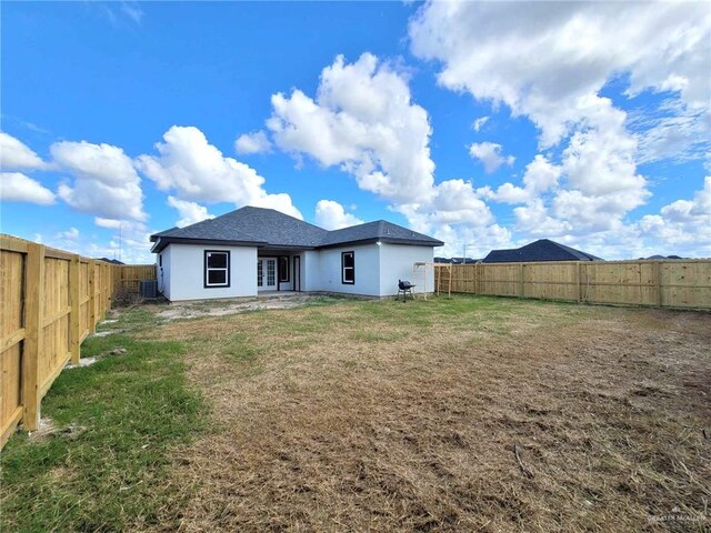 back of house with a yard