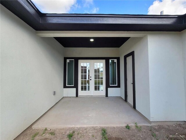 view of exterior entry featuring french doors