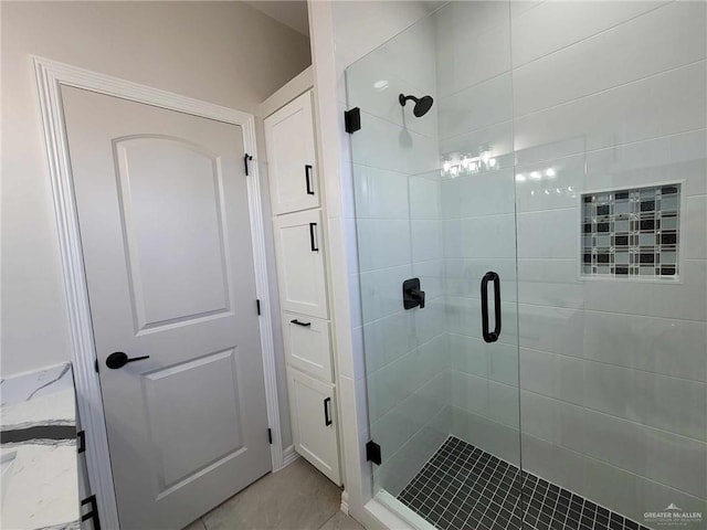 bathroom featuring a shower with shower door