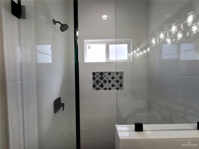 bathroom with tiled shower